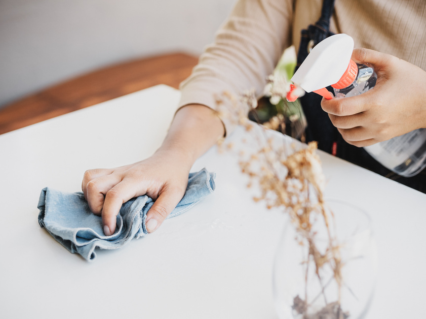 Cleaner Spraying and Wiping White Table 